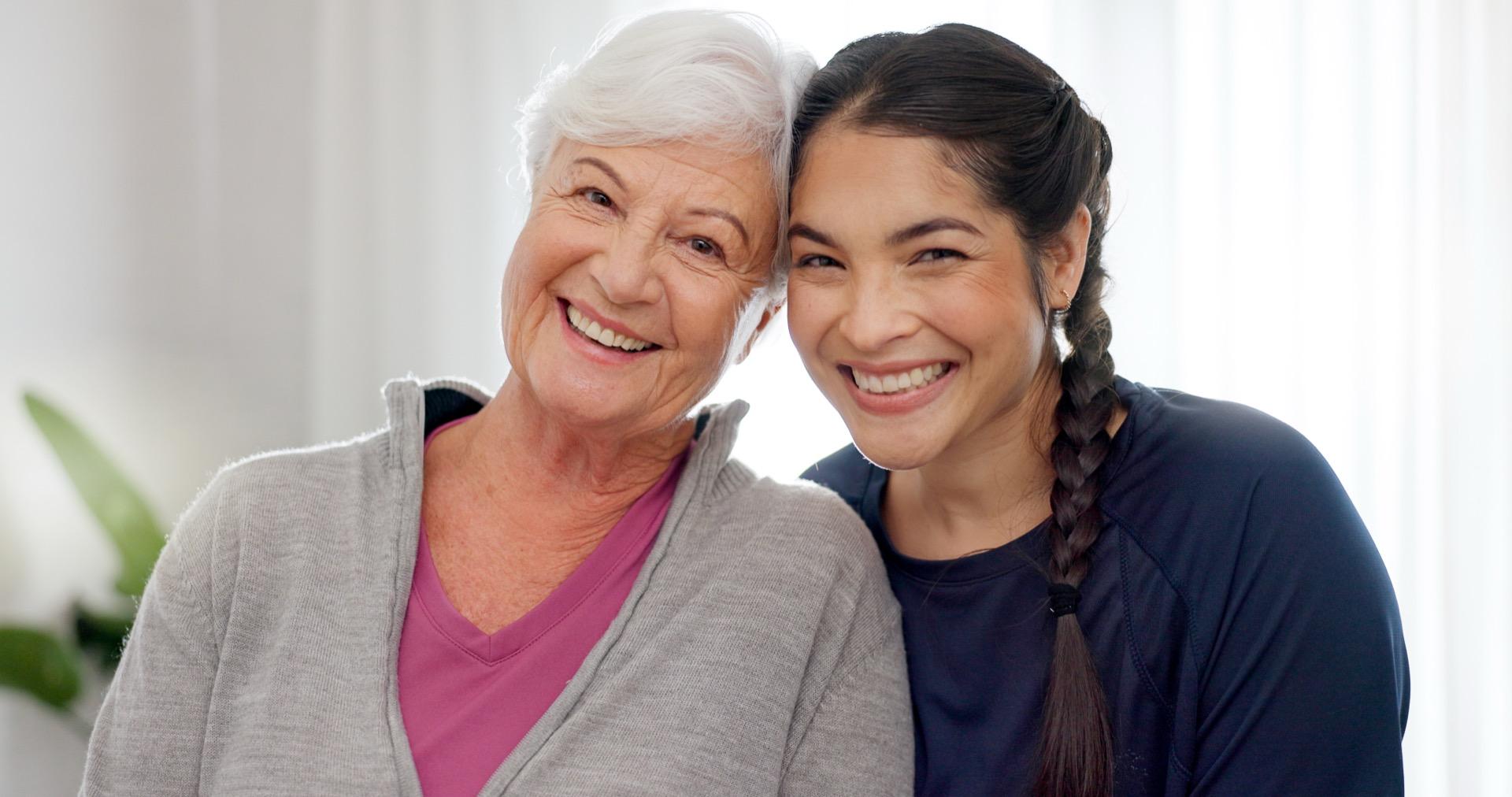 Caregiver helping elderly woman with mobility